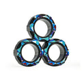 Three patterned black rings with geometric blue designs stacked on white background