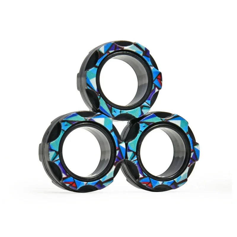 Three patterned black rings with geometric blue designs stacked on white background