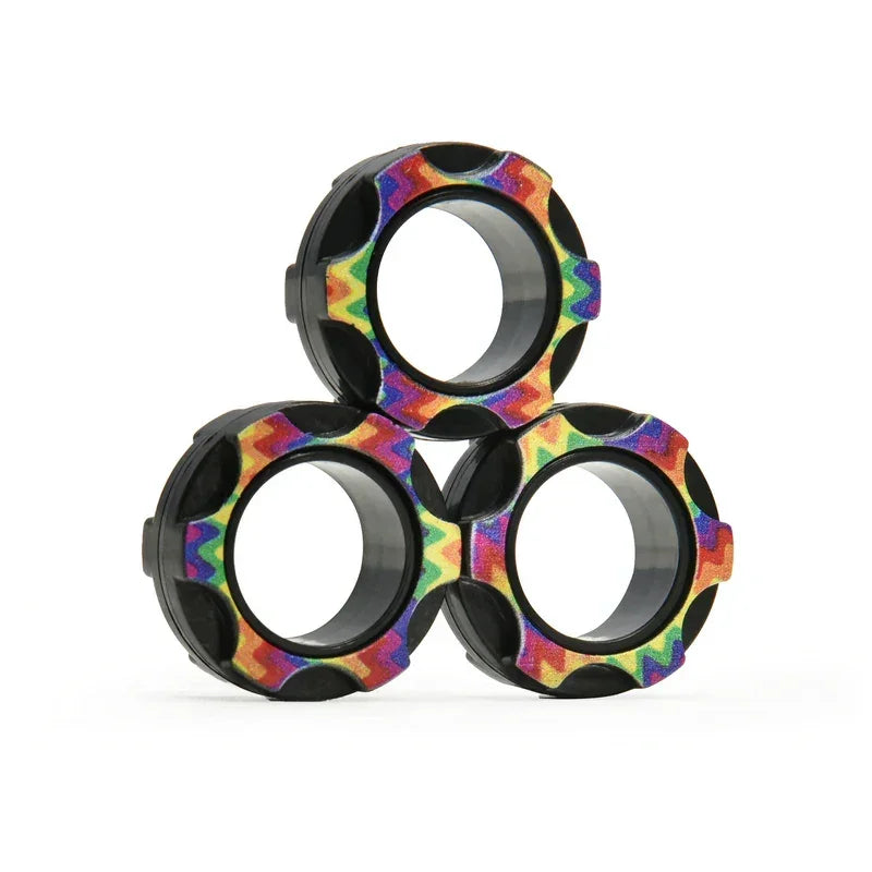Three black and rainbow-patterned round mechanical parts stacked on a white background