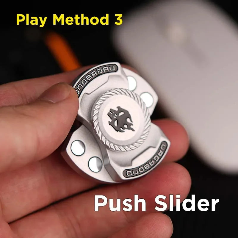 Hand holding a silver metal fidget spinner toy with push slider mechanism