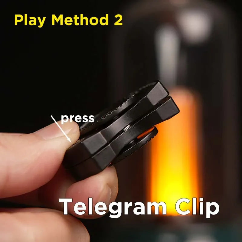 Hand pressing black Telegram Clip fidget toy, play method instructions shown.